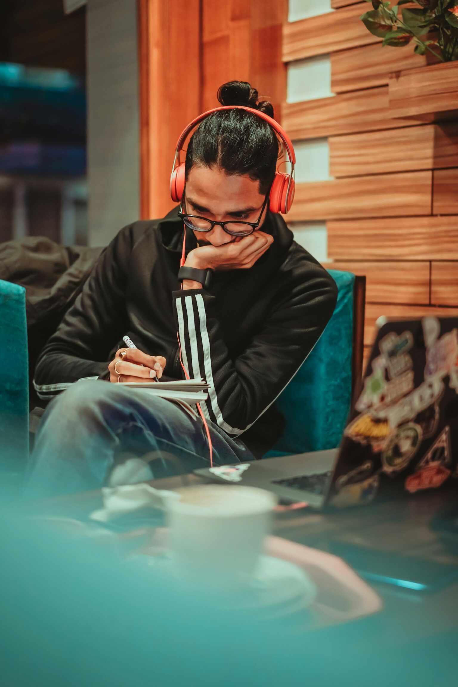person reading book couch headphones