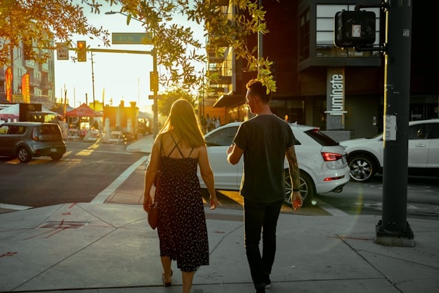 couple walking park golden hour sunset