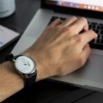 person working laptop clock