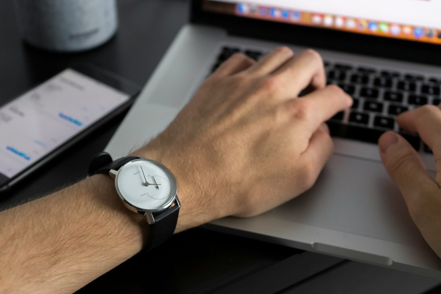 person working laptop clock