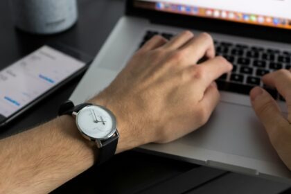 person working laptop clock