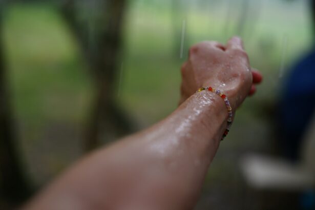 person hand touching glass pane rain outdoors