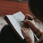person journaling morning light