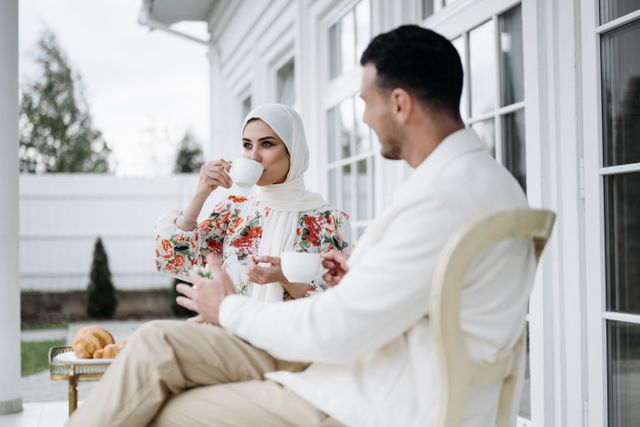 couple drinking coffee balcony morning