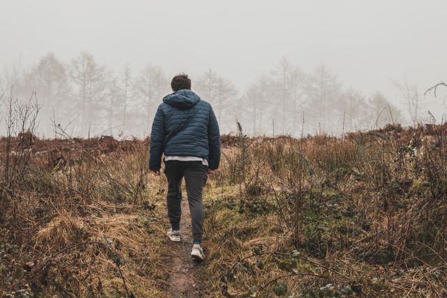 person walking alone forest path