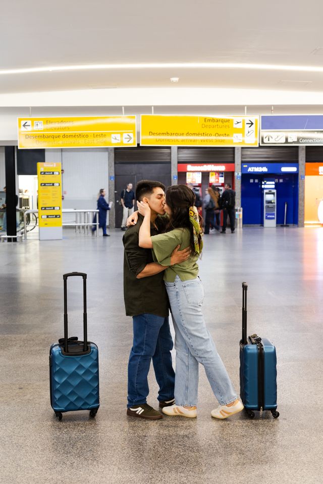 couple emotional embrace departure airport terminal