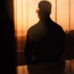 person looking out at a landscape or sunset