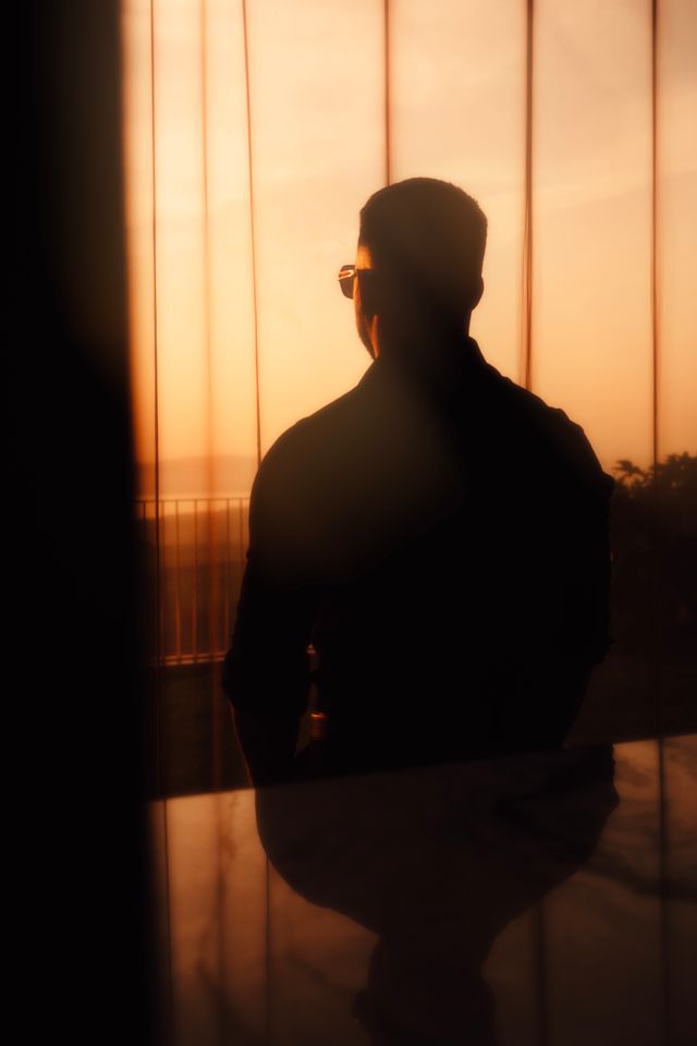 person looking out at a landscape or sunset