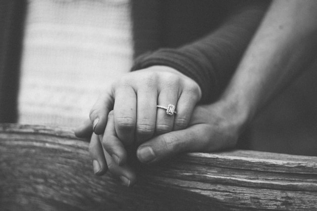 couple holding hands close up touch