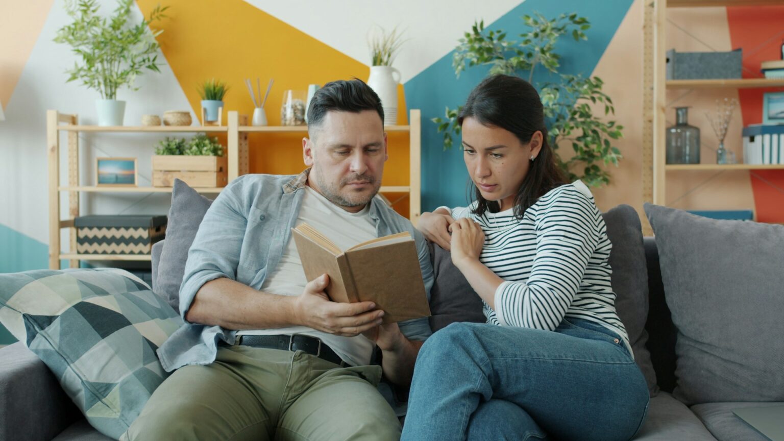 couple talking seriously living room couch