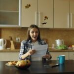 couple sitting at kitchen table talking calmly notebook