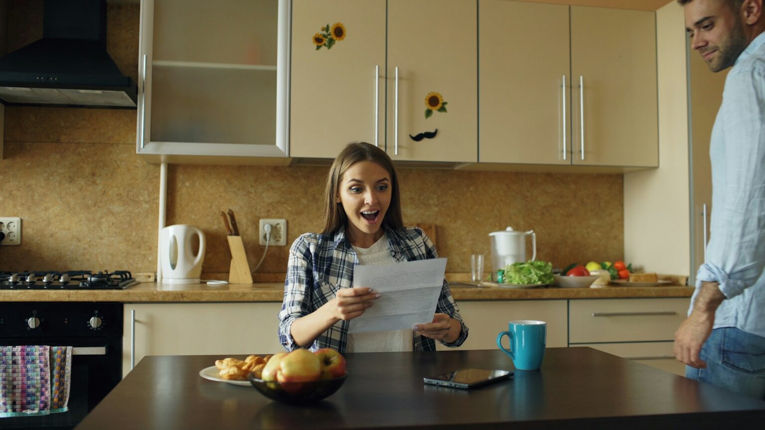 couple sitting at kitchen table talking calmly notebook