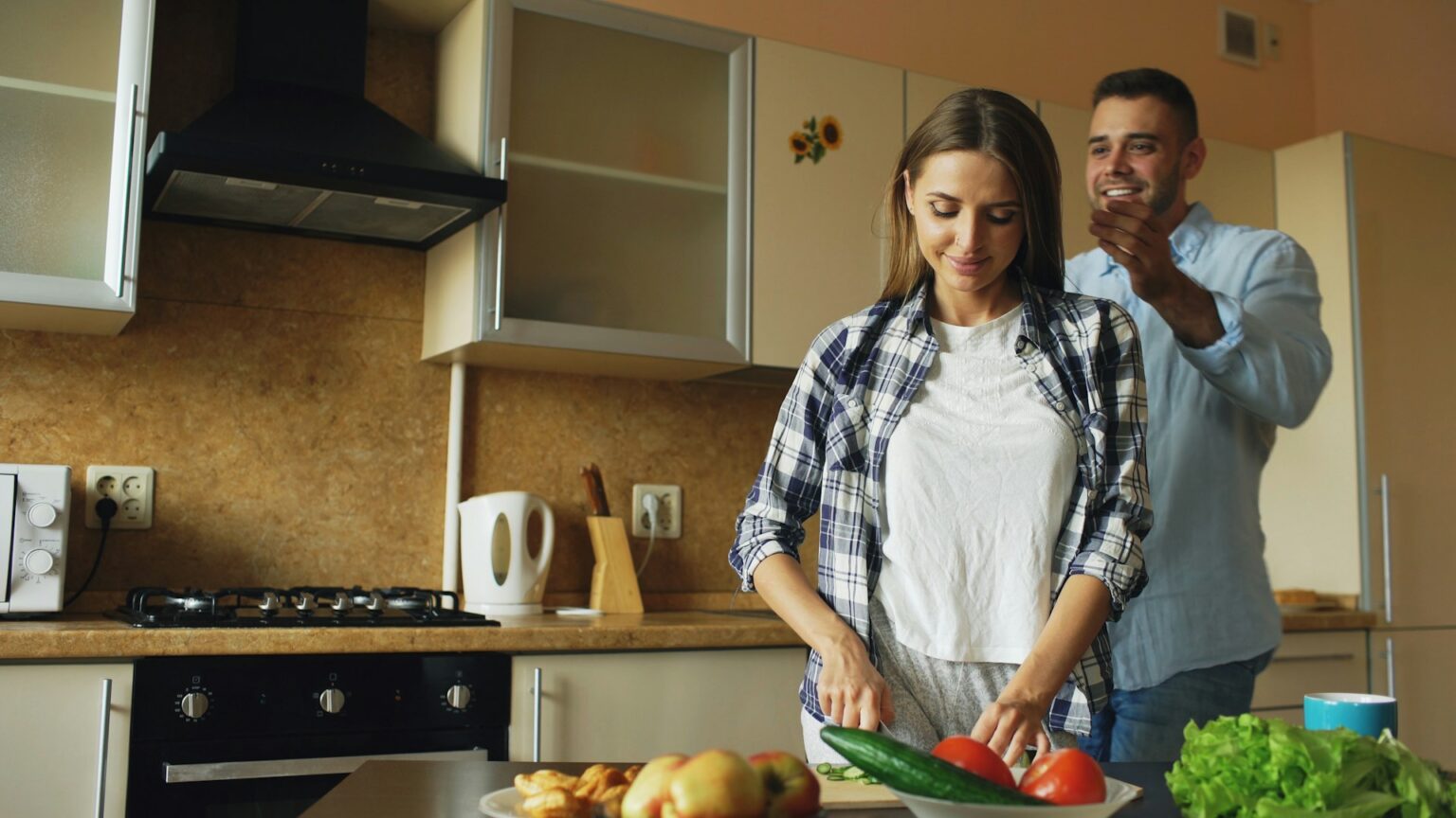 happy couple cooking kitchen laughing domestic