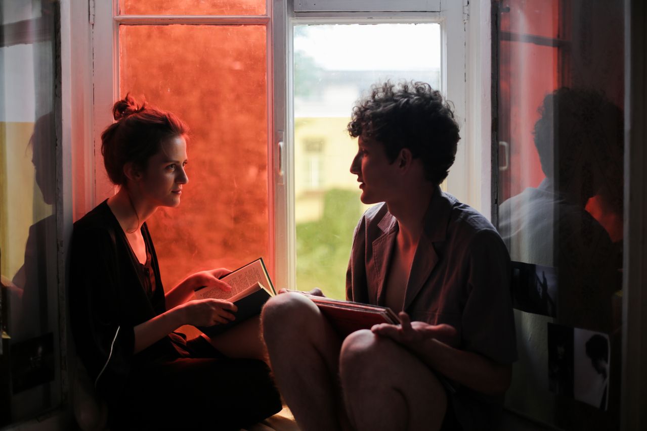 couple reading book cozy window seat